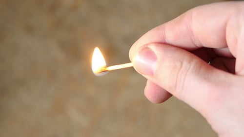 Hand Strikes and Lights a Match Close Up