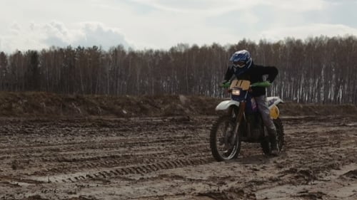 Dirt Bike Rider on a Muddy Course