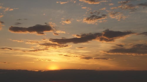 Golden Sunset with Scattered Clouds on the Horizon