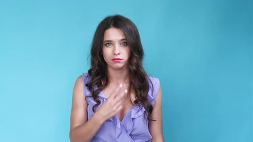 Woman Making Loser Gesture with Fingers and Tongue