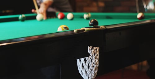 Man Scores a Billiard Ball in the Hole