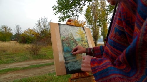 Artist Painting Autumn Landscape in Rural Setting