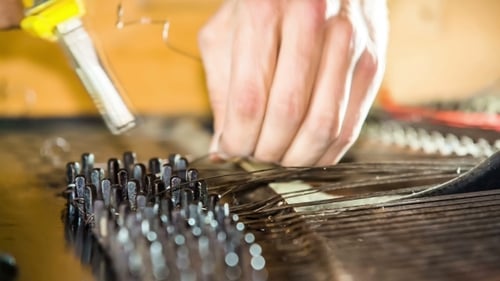 Fixing Interior Piano Strings with Pliers Close Up