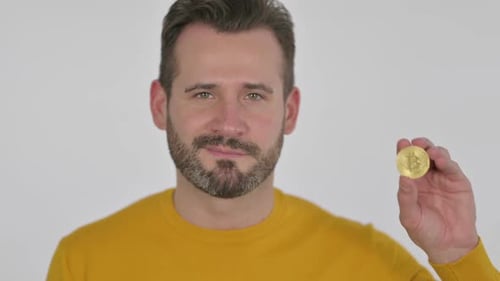 Portrait of Middle Aged Man Holding Bitcoin Crypto Currency