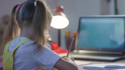 Young Girl Studies Online at Home Desk
