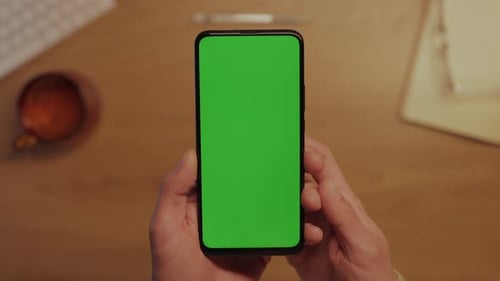 Close Up of Smartphone with Green Screen in Male Hands