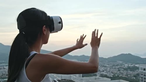 Woman Using VR Headset on Urban Rooftop