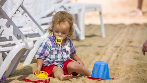 Cute Child Playing on Beach with Toys