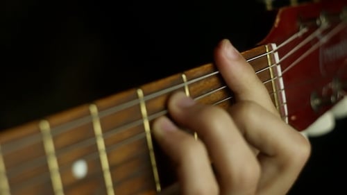 Close Up of Hands Playing Electric Guitar