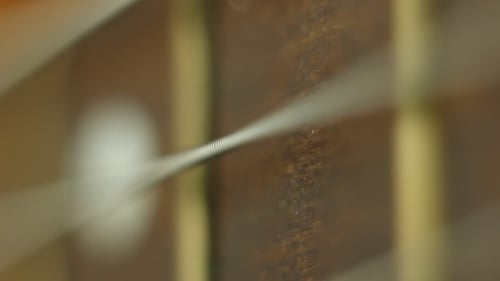 Close-Up of Guitar String Vibrating