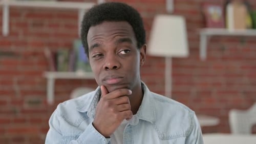 Young Adult Thinking with Hand on Chin