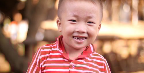Smiling Child in Striped Shirt