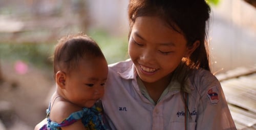 Little Girl Holding Her Younger Sister
