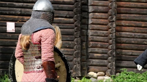 Mann in einem mittelalterlichen Kostüm, der eine Haltung vorbereitet