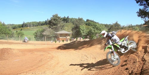 Motocross Riders Speeding on Rural Dirt Track