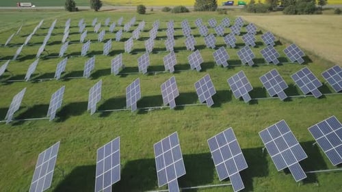 Aerial View of Solar Panel Farm on Green Field