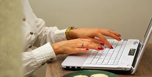 Woman Working on Laptop, Sitting on Sofa at Home, Businesswoman Sits at Home Works Remotely on