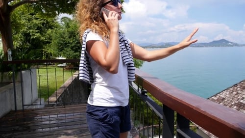 Woman Talking on Phone Overlooking Tropical Ocean View