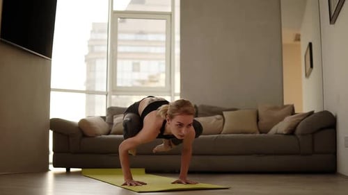 Woman Doing Yoga Routine on Mat in Apartment