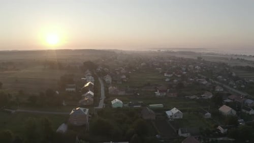 Aerial Drone View Over Old Village at Sunrise. Thick Fog Covered All the Fields