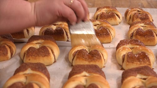 Pastry Baker Glazing Freshly Baked Cinnamon Rolls