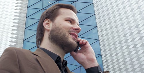 Professional Man Talking on Phone Outside Modern Building