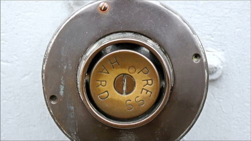 Close-up of Metal "Hard Press" Button