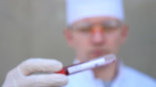 Doctor Examines COVID-19 Blood Sample in Test Tube