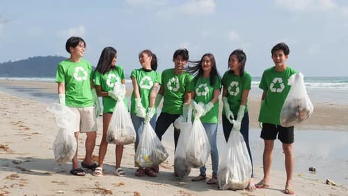 Group of Friends Cleaning Up Beach Together
