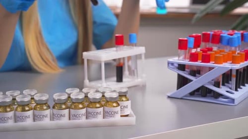 Lab Professional Arranging Blood and Vaccine Vials