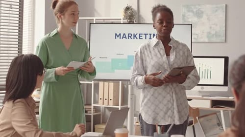 Female Colleagues Making Presentation on Marketing