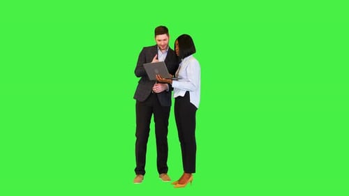 Business Colleagues Discussing Laptop on Green Screen