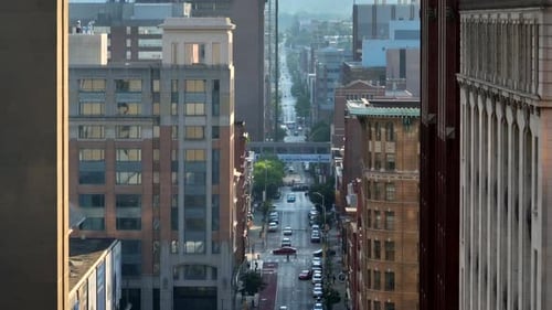 Tight long aerial of skyscraper tower buildings in golden hour light.