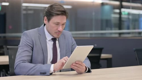 Professional Using Tablet in Office Setting