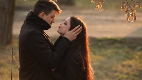 Couple Embracing and Dancing at Golden Hour