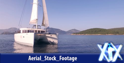 White Catamaran Sails on Calm Waterway