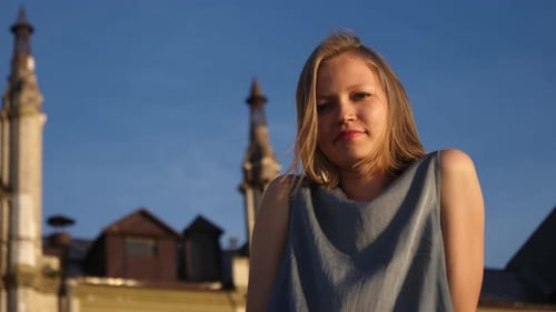 Woman Smiling in Sunlight with Hair Blowing