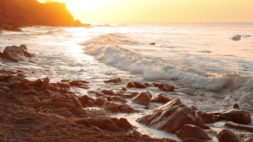 Golden Dawn on the Rocky Shore