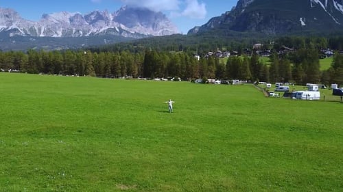 Camera Revolving Around Woman Enjoying the Beauty of Dolomites in the Background