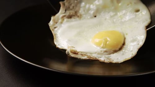 Taking Out Of A Fried Eggs To The Dish
