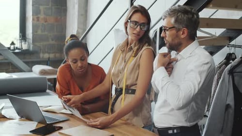 Man Talking with Female Tailors while Ordering Suit in Studio