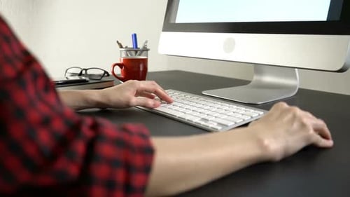 Hands Typing on Keyboard at Modern Computer