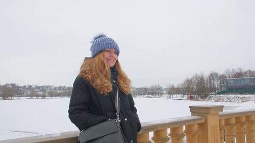Smiling Woman Standing On A Winter Street