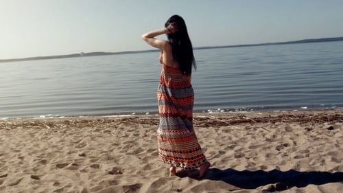 Young Happy Woman Walking On The Sea Beach