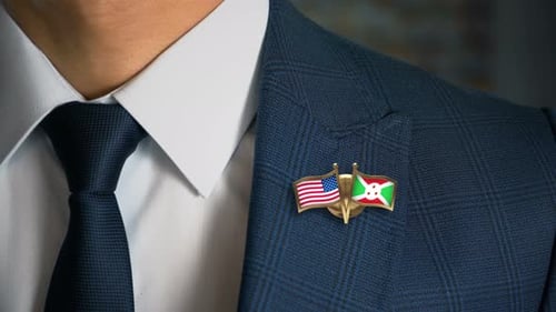 Man in Suit with US and Burundi Flag Pin