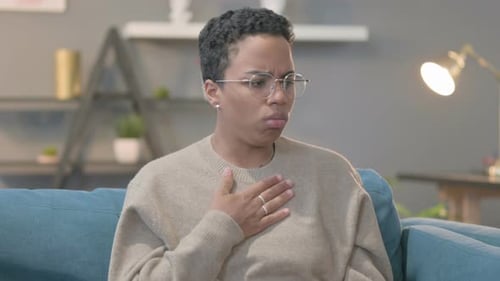 Woman Coughing Due to Illness Indoors