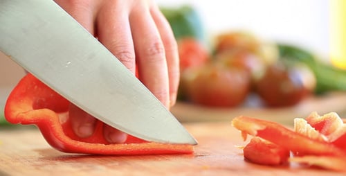 Slicing Fresh Red Bell Pepper in Kitchen