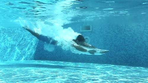 Man Dives Into Swimming Pool Underwater Shot