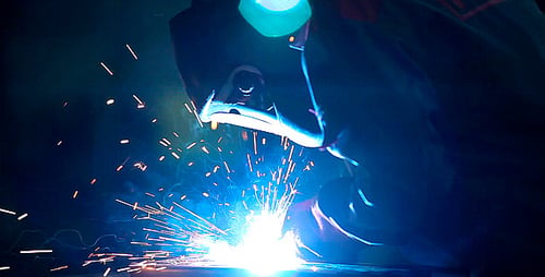 Welder Weld Metal in an Industrial Plant