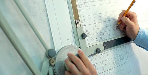 Man Draws a Technical Drawing on Drawing Board